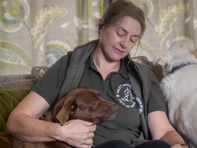 A Mutt and Manor overnight pet sitter in Cheshire dog sits two dogs on a sofa in a house
